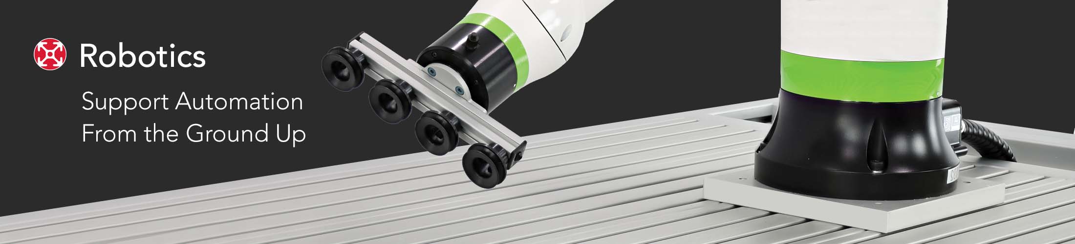 A robotic arm with a custom 80/20 T-slot aluminum end-of-arm tooling (EOAT) attachment featuring vacuum suction cups. The robot is mounted on a heavy-duty aluminum extrusion baseplate next to the text "Robotics: Support Automation From the Ground Up" 