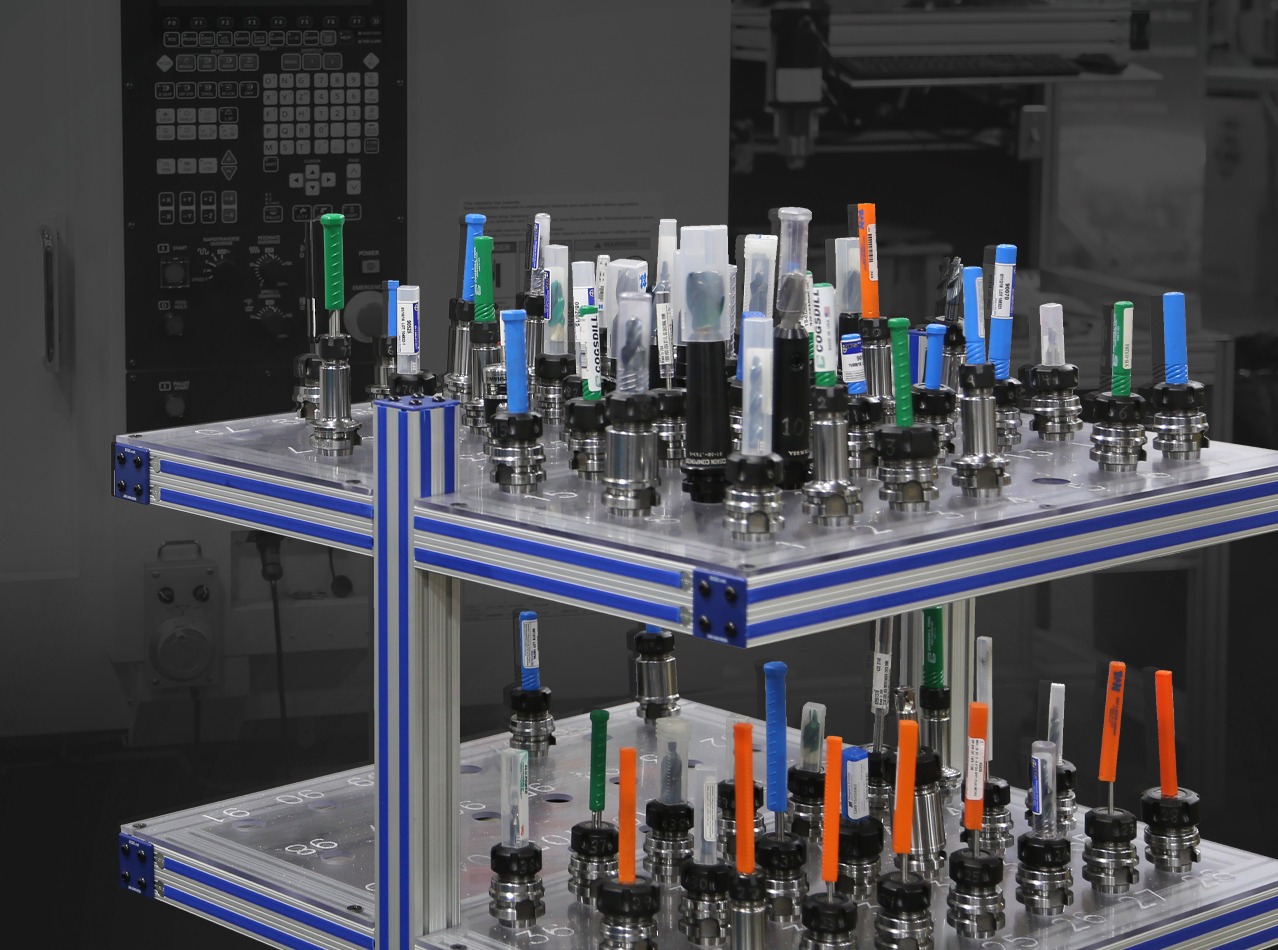 Modular aluminum extrusion tool storage cart with organized CNC tool holders for automotive manufacturing, material handling, machining, and production efficiency.
