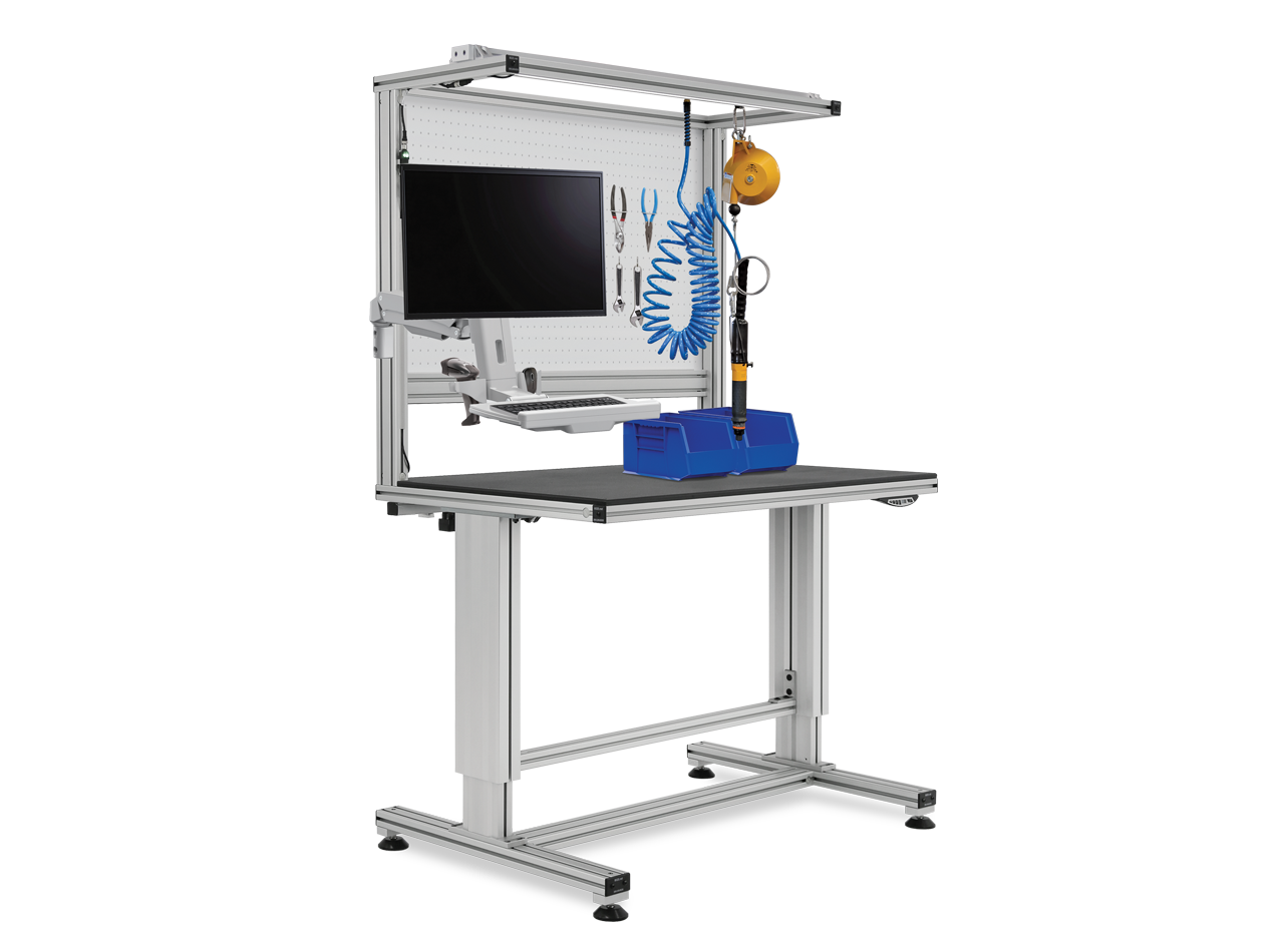 Ergonomic height-adjustable workstation built with T-slot aluminum framing, featuring an articulating monitor arm, keyboard tray, pegboard tool storage, parts bin, and overhead balancer for lean manufacturing, assembly, and industrial production.