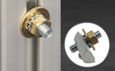 Integrated Ground Point Assembly for ESD-Safe Aluminum Workstations Technical view of a grounding point assembly for T-slot aluminum framing, featuring a brass nut, star washer, and T-nut designed to create a secure electrical bond for ESD protection.