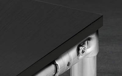 Static-Dissipative Black Worksurface Panel for Industrial Benches Close-up view of a black static-dissipative ESD panel mounted as a worksurface on a T-slot aluminum frame, featuring a clean, square-edge finish without a front wrap.