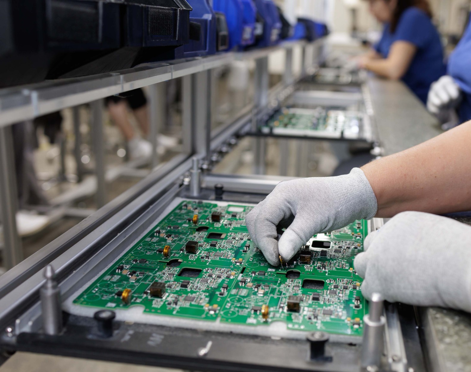 ESD-Safe Electronics Assembly Workstation for PCB Manufacturing Technician assembling printed circuit boards at an ESD-safe workstation designed for electronics manufacturing and production lines.
