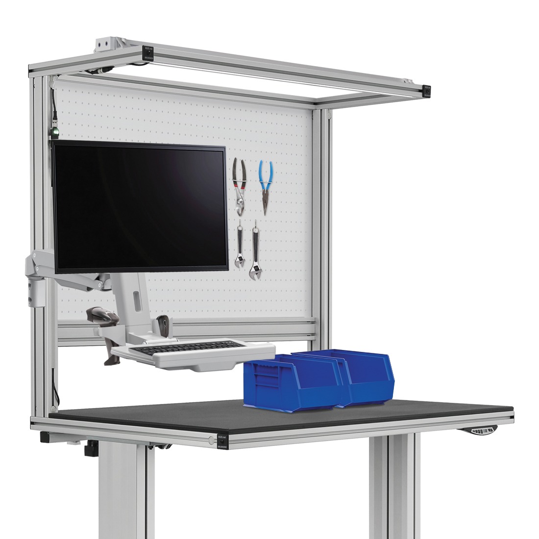 Industrial Assembly Workstation with Monitor Mount and Tool Pegboard Ergonomic industrial workstation featuring a mounted monitor, adjustable keyboard tray, pegboard with tools, overhead frame, and a blue storage bin on the work surface.
