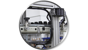 Integrated Wire Management Solutions for T-Slot Aluminum Frames A circular graphic showing organized wire management on a T-slot aluminum frame, featuring black cables neatly routed along the profile channels with secure mounting clips and a multi-wire connector block.