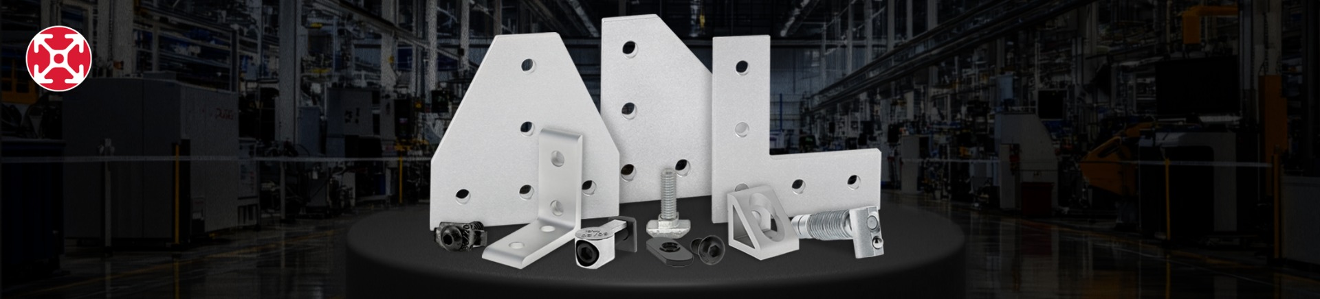 Assorted T-slot fasteners and industrial mounting brackets displayed on a workbench with factory background