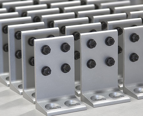 T-Slot Aluminum Corner Brackets & Fasteners for Modular Framing | 80/20 80/20 T-slot aluminum corner brackets with black fasteners for securely joining modular aluminum profiles in industrial workstations, machine guarding, automation equipment, and material handling systems.