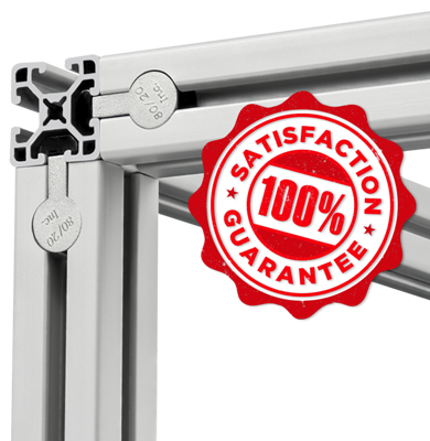 A close-up of a high-quality 80/20 T-slot aluminum frame assembly featuring branded end fasteners. A red "100% Satisfaction Guarantee" badge is prominently displayed over the silver extrusions to highlight product reliability