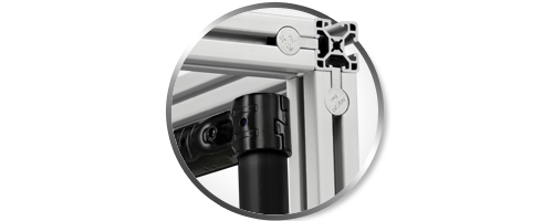 Close-up circular inset showing a 90-degree connection of 80/20 T-slot aluminum profiles using anchor fasteners. A blue upright support with a black connector is positioned in the foreground, demonstrating modular industrial framing assembly.