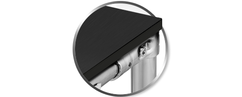 Circular inset showing a close-up detail of a black static dissipative worksurface mounted to a silver T-slot aluminum frame. The image highlights the clean corner interface and industrial mounting hardware used in ESD-safe workstation construction.