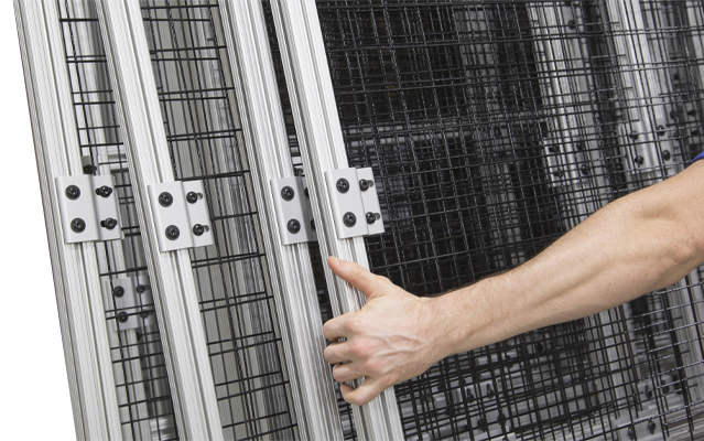 Hand adjusting a modular panel system built with 80/20 T-slot aluminum profiles.