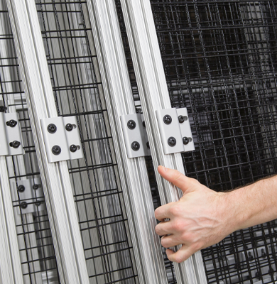 Hand adjusting a modular panel system built with 80/20 T-slot aluminum profiles.