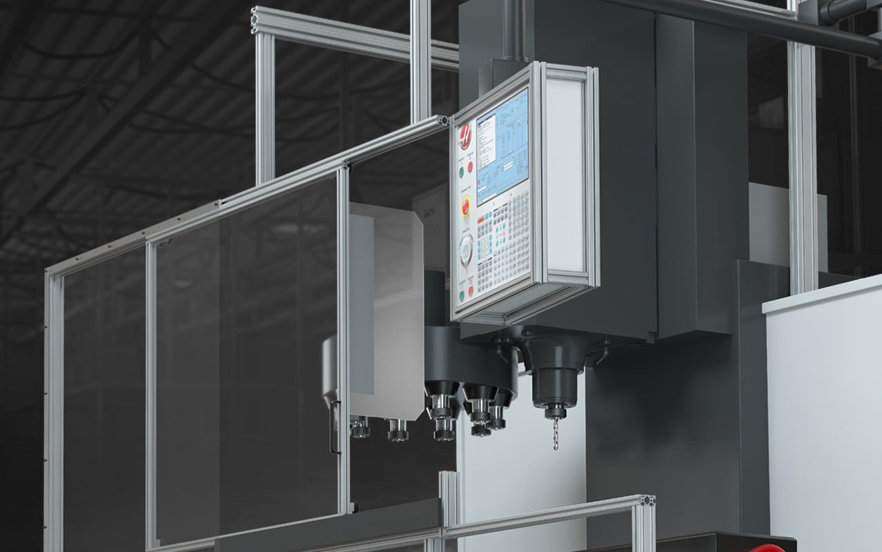 CNC machining center enclosed with an aluminum framing system, protective panels, and integrated control interface designed for machine guarding, safety, and manufacturing efficiency.
