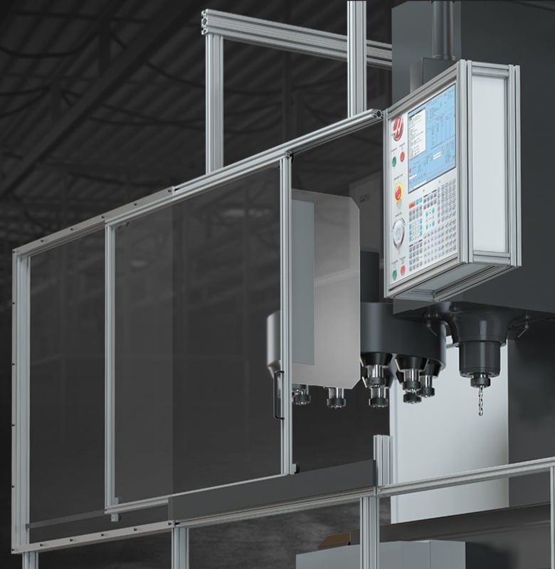 CNC machining center enclosed with an aluminum framing system, protective panels, and integrated control interface designed for machine guarding, safety, and manufacturing efficiency.