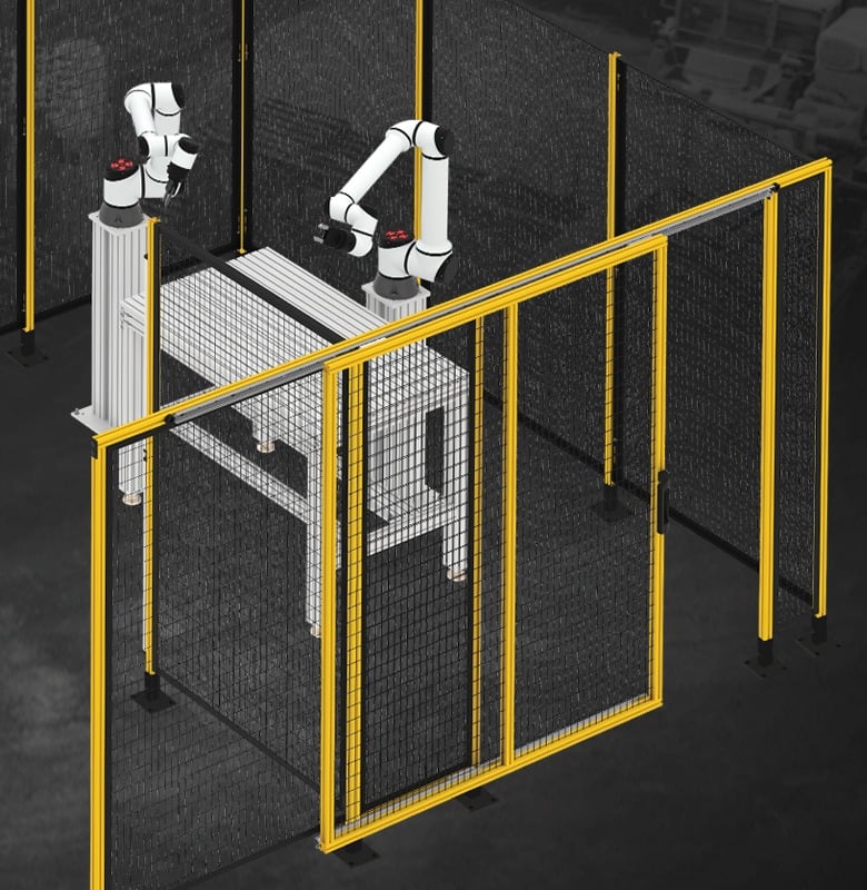 Industrial robotic cell enclosed with machine guarding safety fencing, access doors, and aluminum framing designed to protect personnel and ensure compliance in automated manufacturing environments.