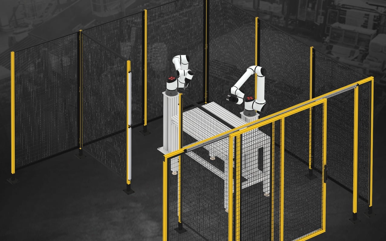 Industrial robotic cell enclosed with machine guarding safety fencing, access doors, and aluminum framing designed to protect personnel and ensure compliance in automated manufacturing environments.