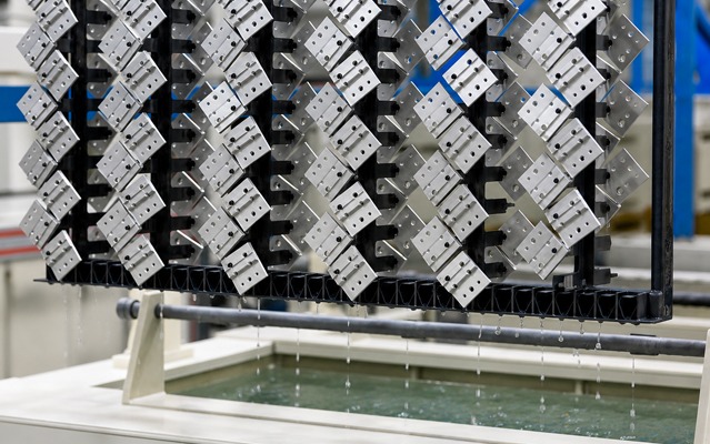 80/20 T-slot aluminum components undergoing the anodizing process in a metal finishing line, providing enhanced corrosion resistance, durability, and a professional appearance for industrial applications.