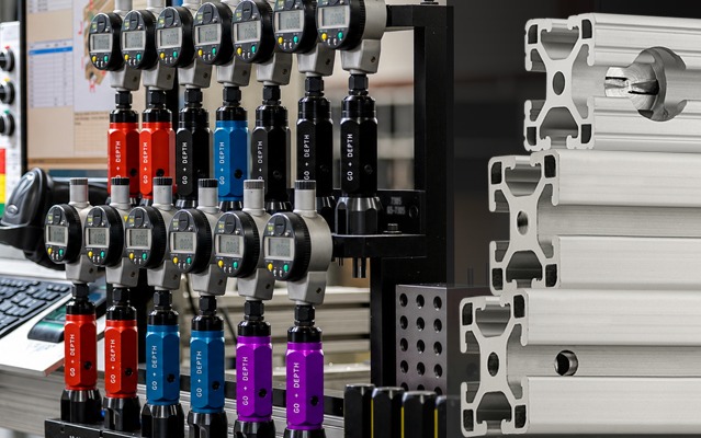 Precision measuring instruments inspecting machined 80/20 T-slot aluminum profiles to verify dimensional accuracy and quality control during manufacturing and machining.