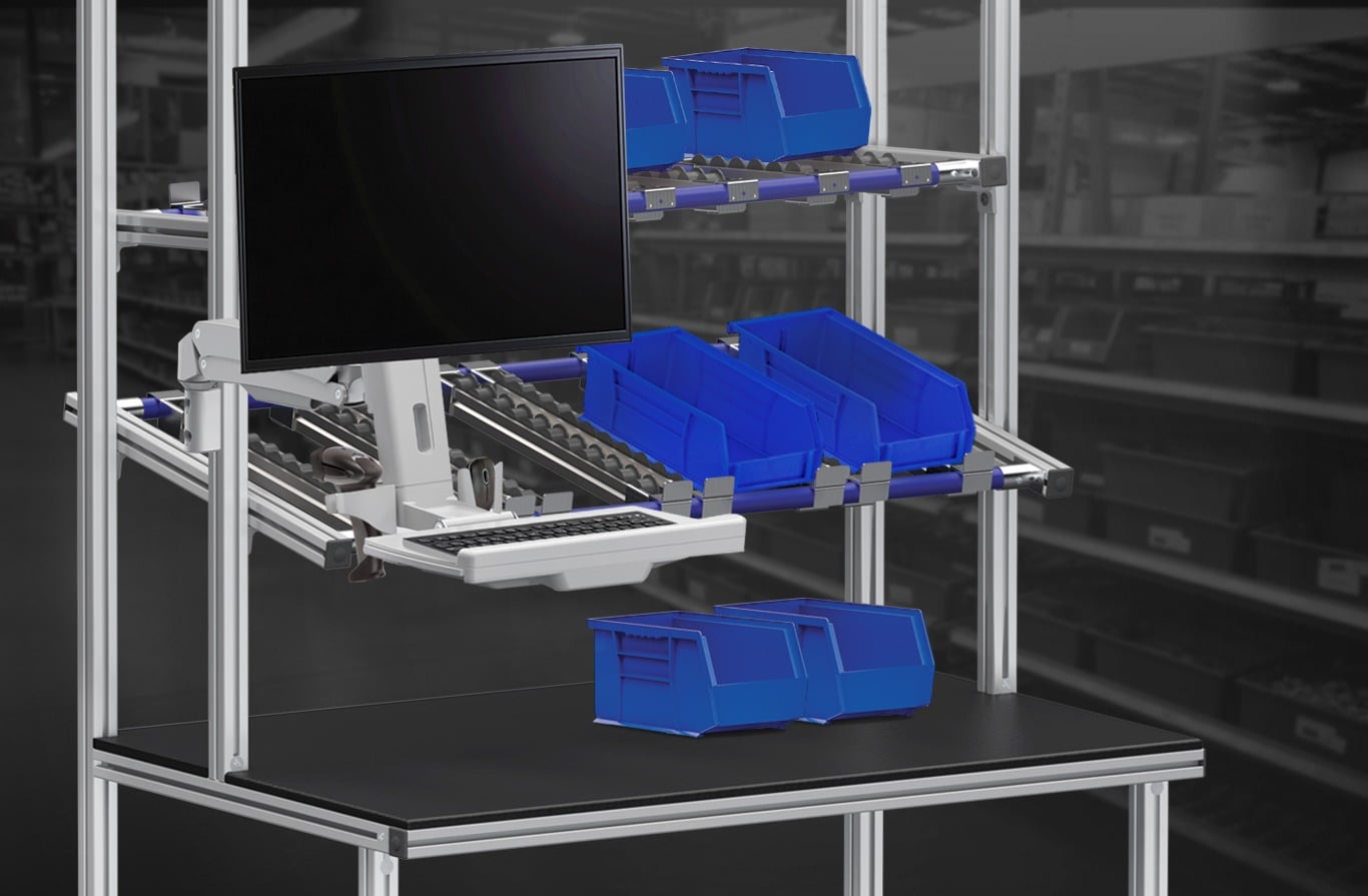 Ergonomic T-Slot Aluminum Workstation with FIFO Flow Rack & Monitor Mount | 80/20 Ergonomic T-slot aluminum workstation featuring FIFO gravity flow racks, adjustable monitor arm, keyboard tray, and parts bins designed to improve material flow, productivity, and operator ergonomics in lean manufacturing environments.