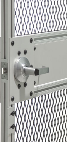 A close-up view of a secure metal door with a silver handle, featuring a reinforced lock plate with rivets and a diamond-patterned wire mesh window.