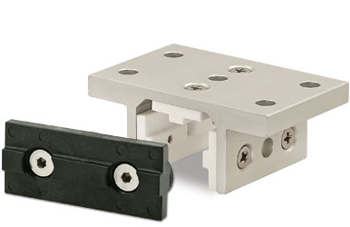 An aluminum plate with fastening elements and a black linear motion bearing.