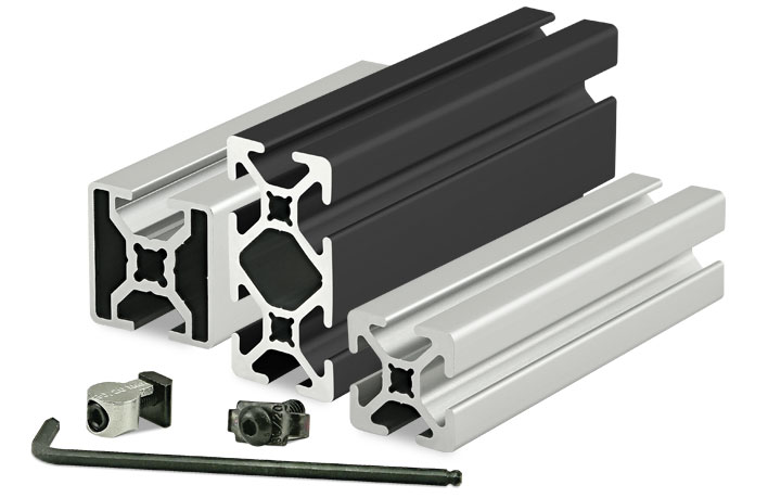 A collection of aluminum extrusion profiles in various shapes and sizes, along with fastening hardware.