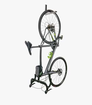 Wall-mounted bike rack holding a bicycle vertically, featuring a black metal frame, isolated on a white background.