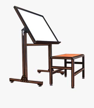 Adjustable drawing table with a tilting top and a matching stool, both with a dark wood finish and metallic bronze-colored frames, isolated on a white background.