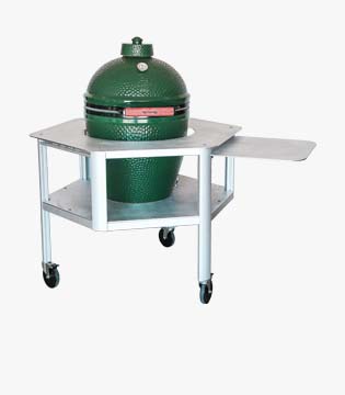 Mobile grill stand with a green ceramic egg-shaped grill, a stainless steel worktop, and side shelves, on swivel casters for portability.