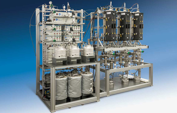 Complex industrial automation system with multiple vessels, piping, and control units mounted on an aluminum frame.