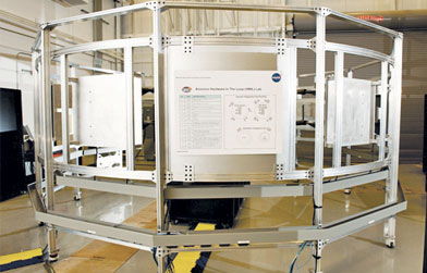 Aluminum extrusion framework structure with an informational poster attached, likely used for industrial applications.