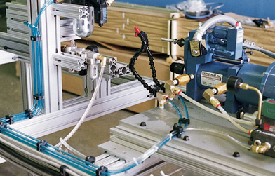 Assorted industrial components and hardware, including brackets, fasteners, and T-slot aluminum extrusion profiles.